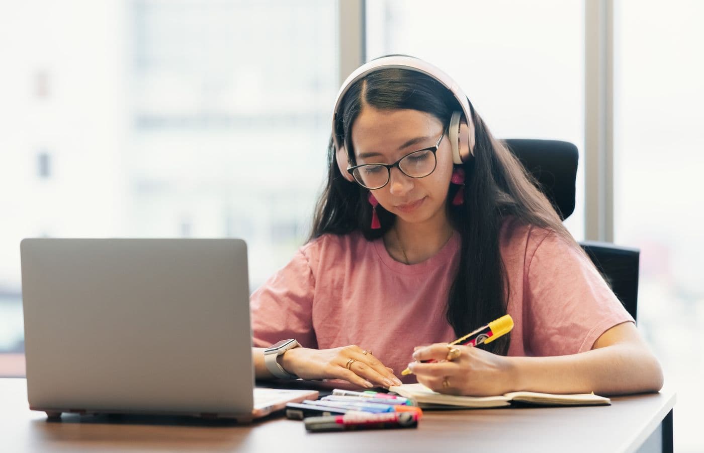 Candidate practising for the TCF TEF Canada online, with headphones